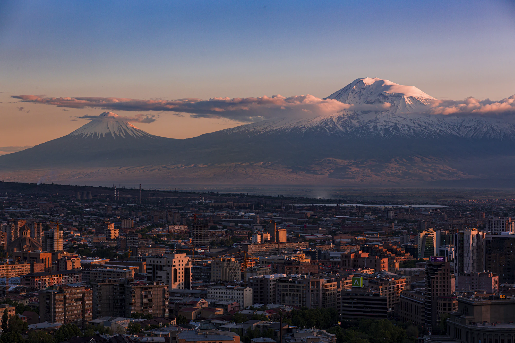 View of Yerevan with snow-capped Mount Ararat in the background at sunset